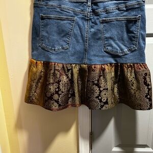 Customized denim skirt with a printed pattern around the bottom.